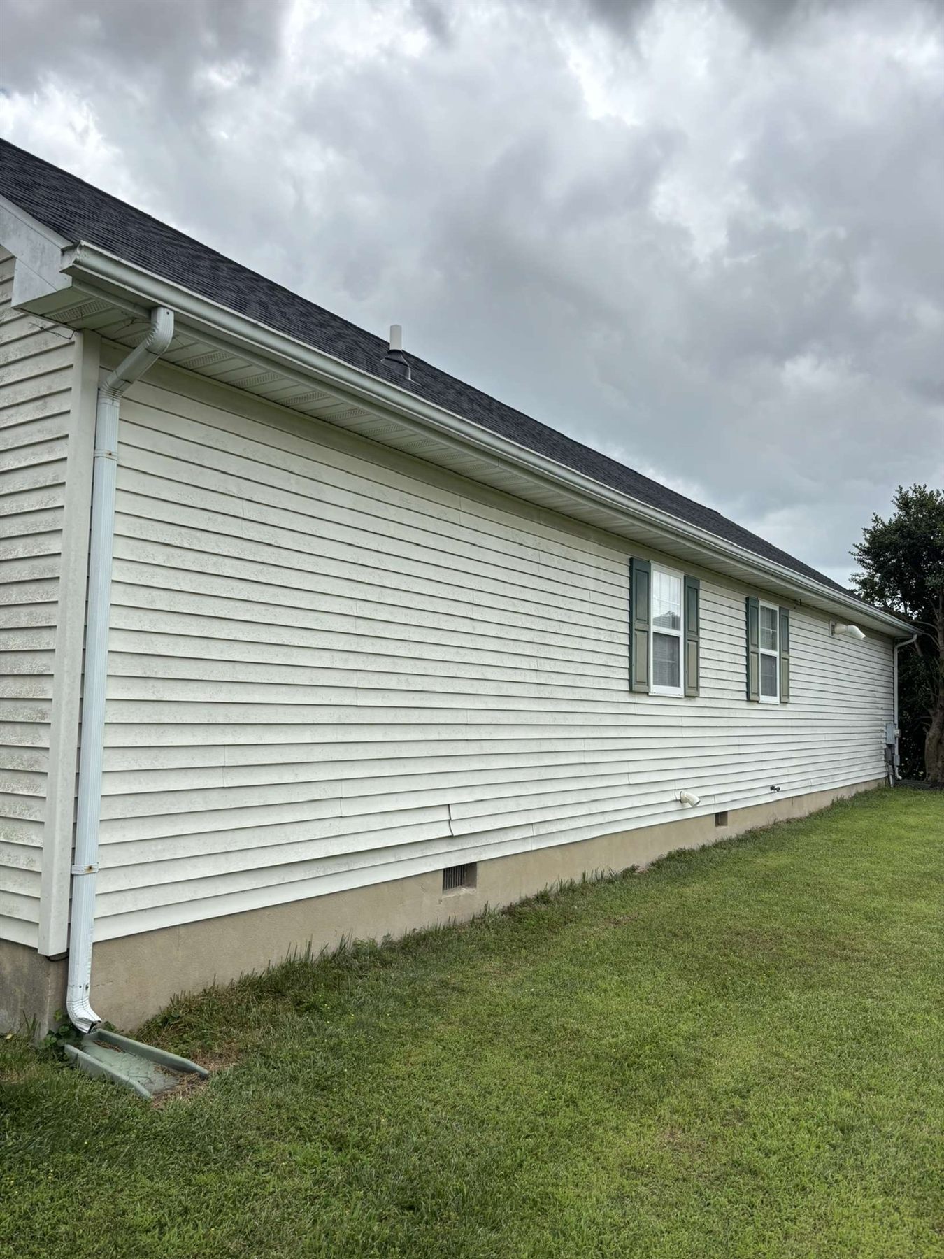 Before house wash showing stained siding in Milford Delaware